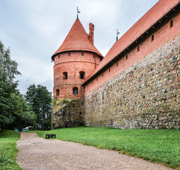 Landscape of ancient Trakai Island Castle with road and tree, Lithuania. Trakai Island Castle and dramatic sky with clouds.