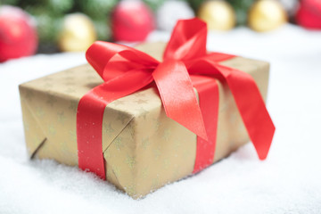 box with red ribbon and bow on white background