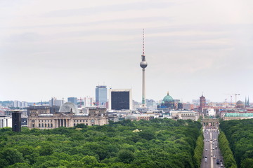 Naklejka premium Berlin summer skyline aerial view of Brandenburger Tor - Brandeburg gate and television tower Fernsehturm with cars passing crossroad under Victory Column in Tiergarten, Berlin, Germany