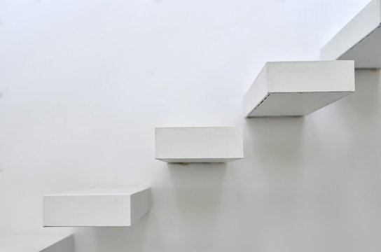 White wooden steps mounted in the wall