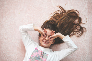 Fototapeta premium Portrait of a happy laughing child girl
