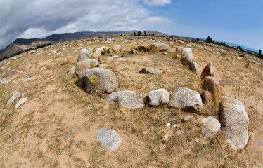 Stone circles in Cholpon Ata open air museum with ancient rock paintings, Issyk-Kul lake shore, Kyrgyzstan,Central Asia,unesco heritage