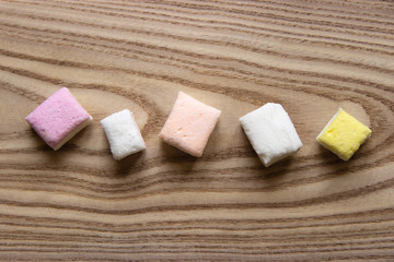 Colorful marshmallow on wooden surface. Top view