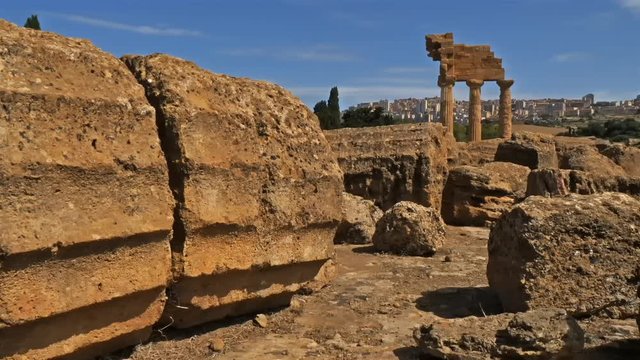 Agrigento,Valley of the Temples, Syracuse, Sicily, Italy. Ruins of the Temple of Castor and Pollux. In the background is the modern city.