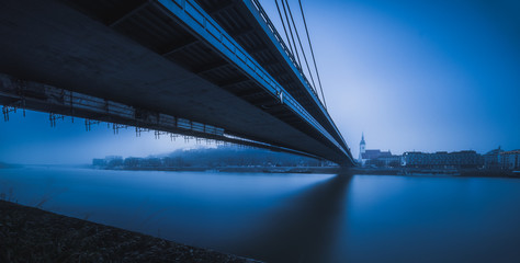 Bratislava Skyline with Bridge over Danube River in Blue Tones