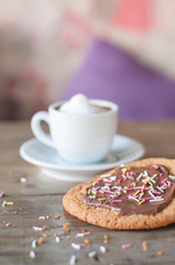 Chocolate sugar cookie with fresh cream macchiato on rustic wood