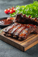 Closeup of pork ribs grilled with BBQ sauce and caramelized in honey. Tasty snack to beer on a...