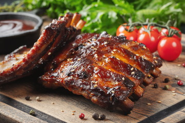 Closeup of pork ribs grilled with BBQ sauce and caramelized in honey. Tasty snack to beer on a...