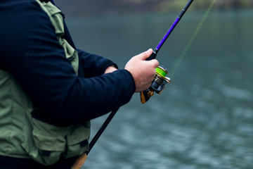 Fisherman holding fishing rod