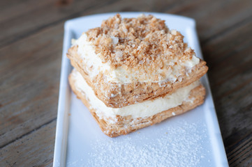 Mille-feuille is known vanilla or custard slice on white plate