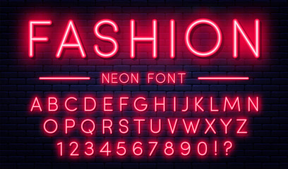 Neon alphabet with numbers. Red neon style font, fluorescent lamps on brick wall background © Yevhenii