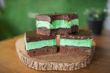 Mint brownies on wood with green background