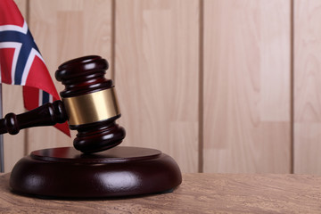 Flag of Norway and a gavel on a sounding block