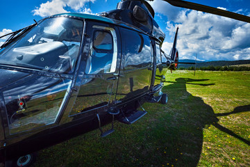 Private black helicopter on a field © bdavid32