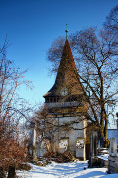 Bell tower of Gothic Protestant Church of Avas an old historical building and symbol of city of Miskolc in sunny winter day from snow-covered Avas cemetery, Northern Hungary Central / Eastern Europe