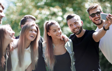 group of friends taking selfies in the Park