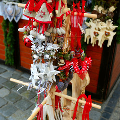 Wooden multi-colored Christmas toys for decorating house at Christmas Market. Wroclaw xmas market in Europe on holidays. 
