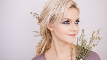Naklejka premium Portrait of an elegant young woman with blond hair. Trendy hairstyle