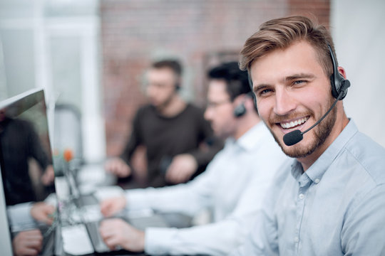 smiling business center staff sitting at the Desk