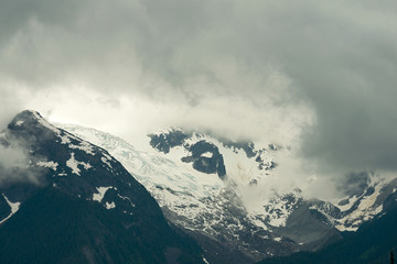 Fototapeta na wymiar Storm clouds covering the glacier on Oscar Peak in British Columbia, Canada