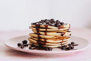 Stack of delicious homemade pancakes with sauce