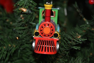 Toy train engine Christmas ornament on tree
