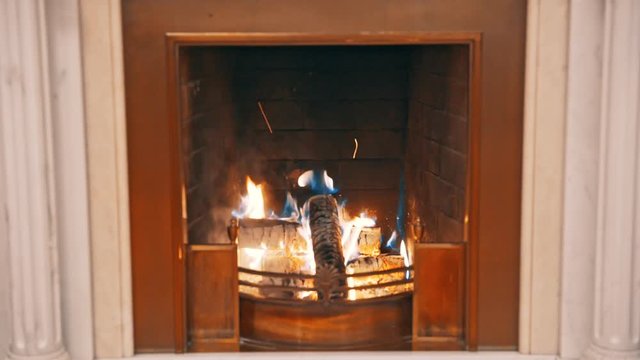 Classic fireplace with real burning fire and coals