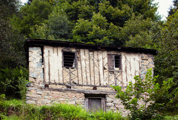 View of traditional, wooden/stone house at high plateau and forest. The image is captured in Trabzon/Rize area of Black Sea region located at northeast of Turkey.