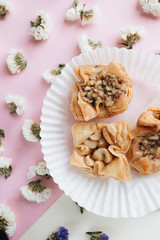 Fototapeta na wymiar Baklava sweet dessert. Pastry made of layers of filo filled with chopped nuts and sweetened and held together with syrup or honey