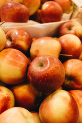 Pile of fresh ripe red apples in boxes at market