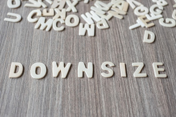 DOWNSIZE word of wooden alphabet letters. Business and Idea concept