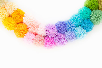 Pompons of colored yarn. White background. Bright colours.