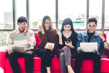 Group of business sitting relax use technology together of smartphone and laptop computer checking social apps and working.Communication concept