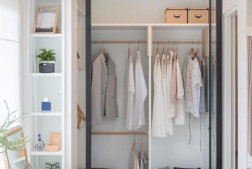 modern closet with clothes hanging on rail