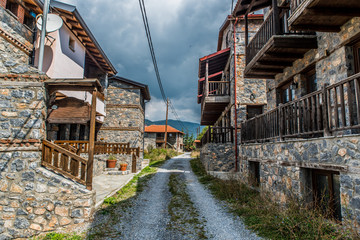 Fototapeta na wymiar traditional alley at Agios Athanasios village in Macedonia Greece near the snow center of Kaimaktsalan