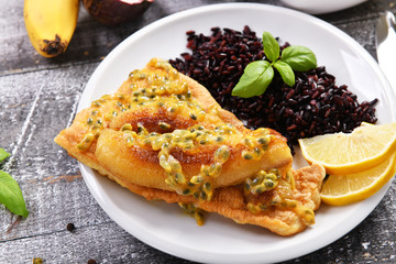 Traditional madeira dish - scabbardfish with bananas and passion fruit