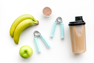 nutrition for workout with protein cocktail and banana on white background top view mockup