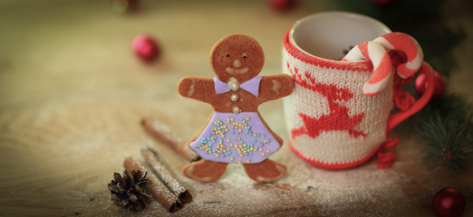 Christmas Cup ornament and candy on a wooden table