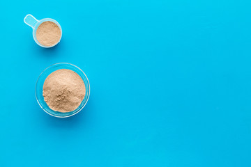 protein cocktail with powder for sport nutrition set l on blue background top view mock-up