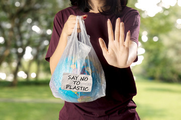 Young woman gesturing stop plastic pollution