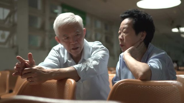 Asian senior couple encourage each other after medical result at hospital