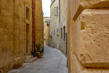 A view of old Mdina street with a residental houses with a traditional Maltese style multicolored balconies, Malta.