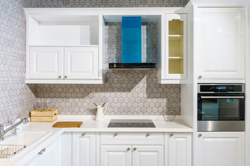 New modern, bright, clean, kitchen interior with stainless steel appliances in a luxury house