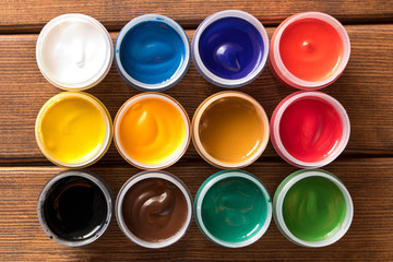 Various paints on the old wooden table . Creative concept. Top view