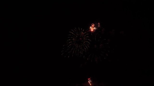 Slow motion fireworks show, half rings and red balls with glitter