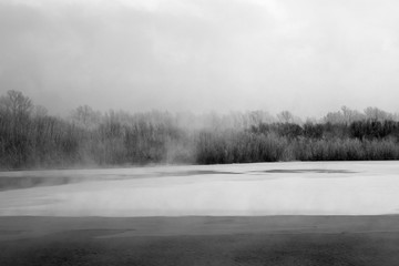 Winter landscape. The ice on the river. The mist over the water. Low air temperature. - 238124644