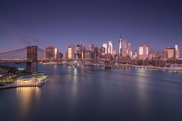 Fototapeta na wymiar Aerial view on East river with Brooklyn Bridge and financial district at night,long exposure