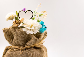 Artificial flowers in Sack on background