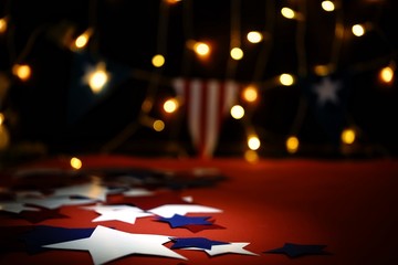 Fireworks display celebrates the independence Day of the United States of America nation on the fourth of July with the us flag , sparklers , candy, on the red background and on the background of