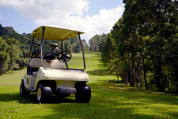 Golfcar in beautiful golf course in the evening golf course with sunshine